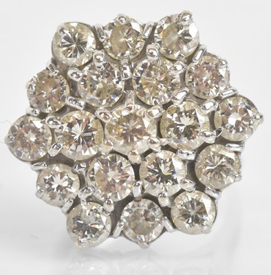 Lot 1228 - An 18ct white gold diamond cluster ring, each...