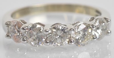 Lot 35 - A white metal five stone diamond ring,...