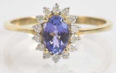 Lot 1124 - A yellow metal tanzanite and diamond cluster...