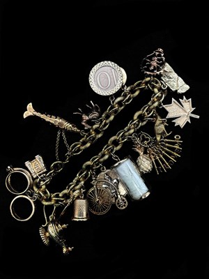 Lot 1175 - A substantial yellow metal charm bracelet, the...