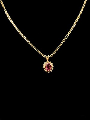 Lot 1176 - A yellow metal chain stamped 14kt, suspending...