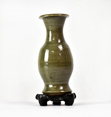 Lot 212 - A celadon glazed hunping funerary baluster...