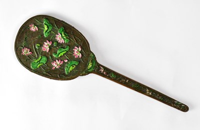 Lot 201 - A Chinese hand mirror decorated with lotus...