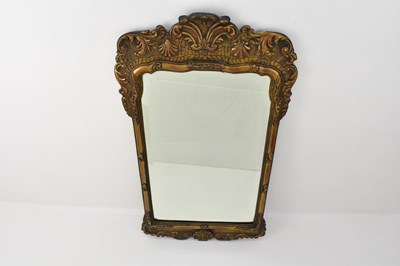 Lot 129 - A reproduction bevelled edge shaped mirror...