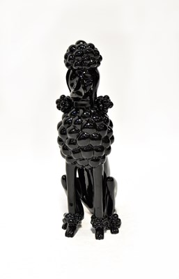 Lot 244 - A black lacquered sculpture of a seated poodle,...