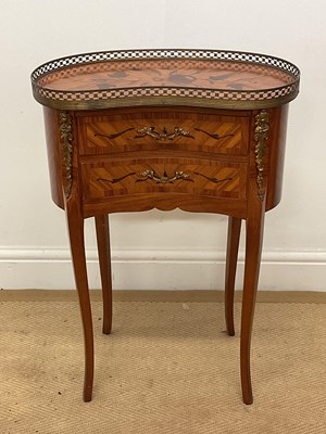 Lot 582 - A French kidney shaped kingwood veneered and...