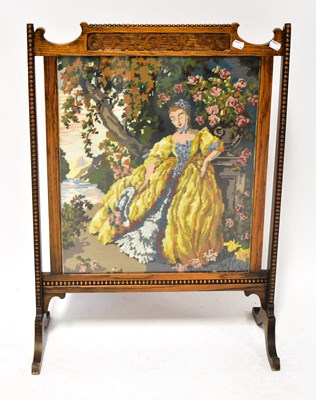 Lot 82 - A 1930s oak fire screen with beaded and carved...