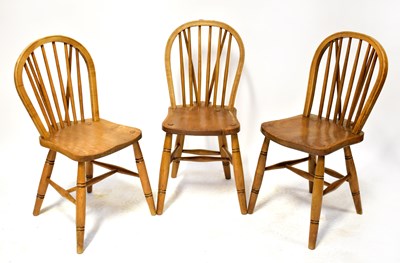 Lot 67 - Three elm hoop and stick back dining chairs on...