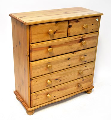 Lot 37 - A waxed pine chest of two short over four long...