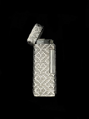 Lot 1149 - A textured 18ct white gold lighter of rounded...