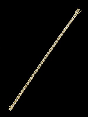 Lot 1150 - An 18ct yellow gold diamond tennis bracelet...