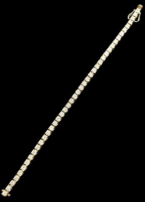 Lot 1151 - An 18ct yellow gold diamond tennis bracelet...