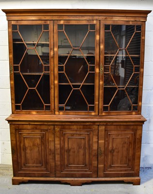 Lot 117 - A reproduction yew wood triple breakfront...