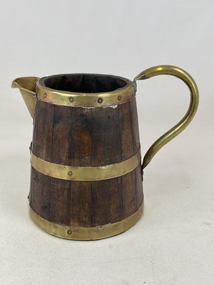 Lot 561 - A brass bound oak pitcher, height 27cm.