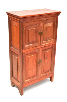 Lot 83 - A small stained pine side cabinet, with hinged...