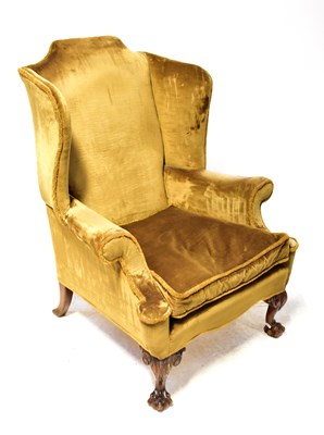 Lot 50 - An early 20th century wingback armchair, with...