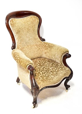Lot 57 - A Victorian mahogany spoon-back elbow chair,...