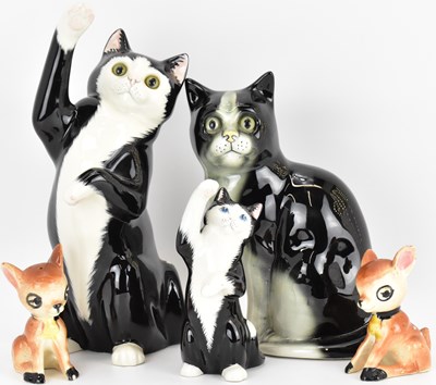 Lot 438 - Three porcelain cats, two with glass eyes, and...