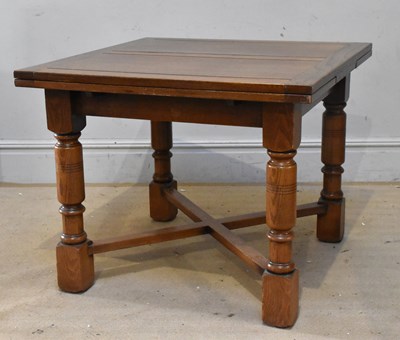 Lot 1298 - A 1920s oak draw-leaf dining table, on turned...