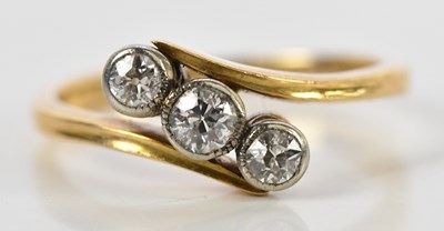 Lot 152 - A yellow metal diamond three stone ring, with...