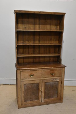 Lot 1042 - An old pine dresser, with boarded plate rack...