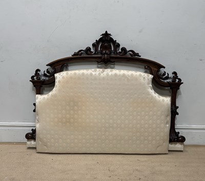 Lot 1292 - A carved upholstered headboard (adapted from a...