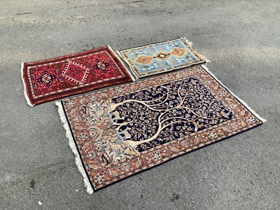 Lot 1322 - A navy ground Eastern style rug, decorated...
