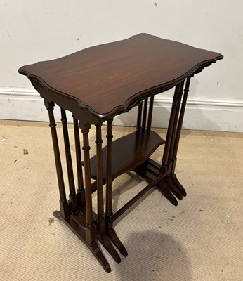 Lot 1260 - A mahogany nest of three serpentine tables,...
