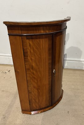 Lot 1217 - A George III oak and mahogany bowfront hanging...