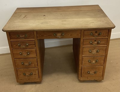Lot 593 - A pine kneehole desk, with the central drawer...