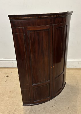 Lot 1224 - A George III mahogany bowfront hanging corner...