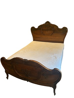 Lot 1188 - A French Louis XV style walnut bed, with...