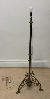 Lot 1566 - An Edwardian brass standard lamp on tripod...