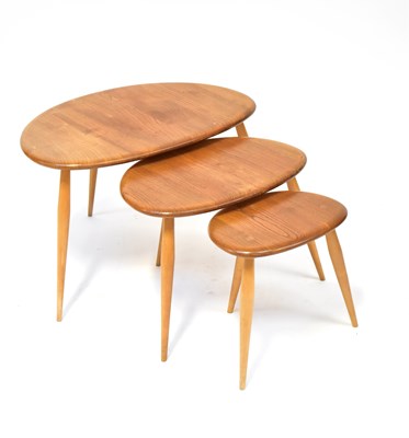 Lot 3 - ERCOL; a nest of three blonde elm 'Pebble'...