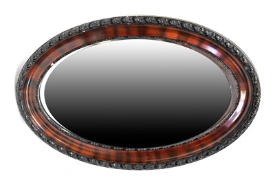 Lot 125 - A contemporary oval wall mirror with bevelled...