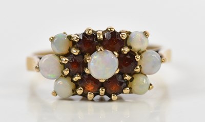 Lot 158 - A 9ct gold garnet and opal dress ring, size R...