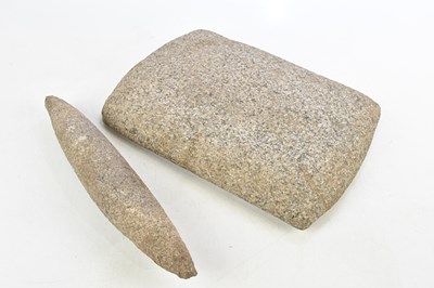 Lot 1336 - A stone grain grinder, 38 x 27cm.