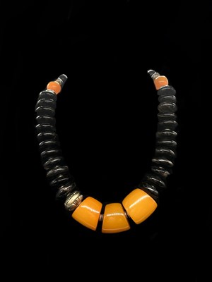Lot 1286 - A vintage Eastern black amber and egg yolk...
