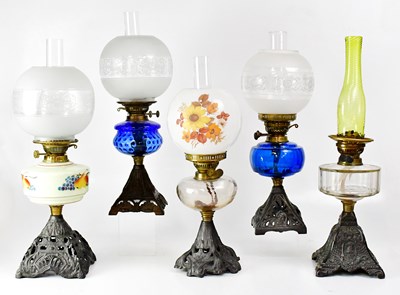 Lot 164 - Five oil lamps with cast metal bases, two with...