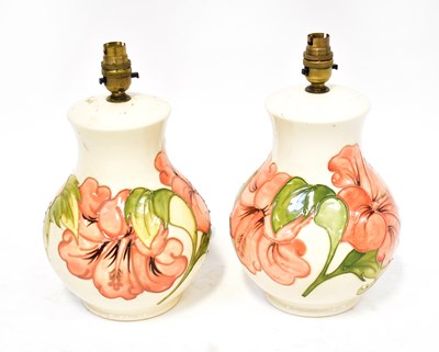 Lot 267 - MOORCROFT; a pair of cream ground 'Hibiscus'...