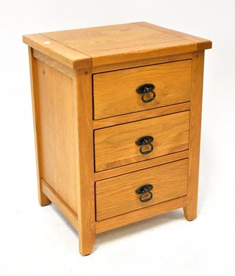 Lot 30 - A contemporary oak three-drawer bedside table,...