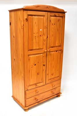 Lot 46 - A modern pine two-door wardrobe, with pair of...