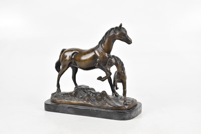 Lot 1555 - A reproduction bronze model of a horse and...