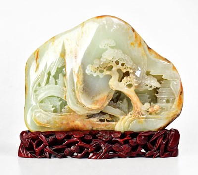 Lot 220 - A Chinese russet and celadon coloured jade...