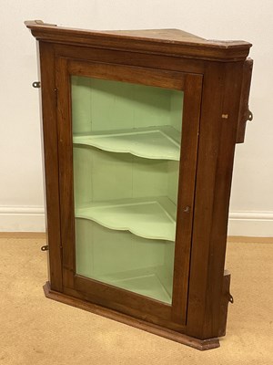 Lot 662 - An oak corner cabinet with glazed door and two...