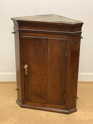 Lot 664 - An oak corner cabinet, with two internal...