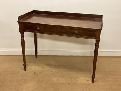 Lot 653 - A mahogany writing table with two drawers,...