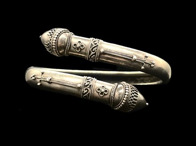 Lot 1110 - A white metal filigree decorated bangle,...