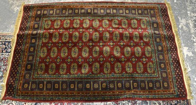 Lot 2668 - A modern machine woven wool Bokhara type rug,...