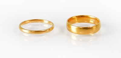 Lot 816 - Two 22ct gold wedding bands, width 2mm and 4mm,...